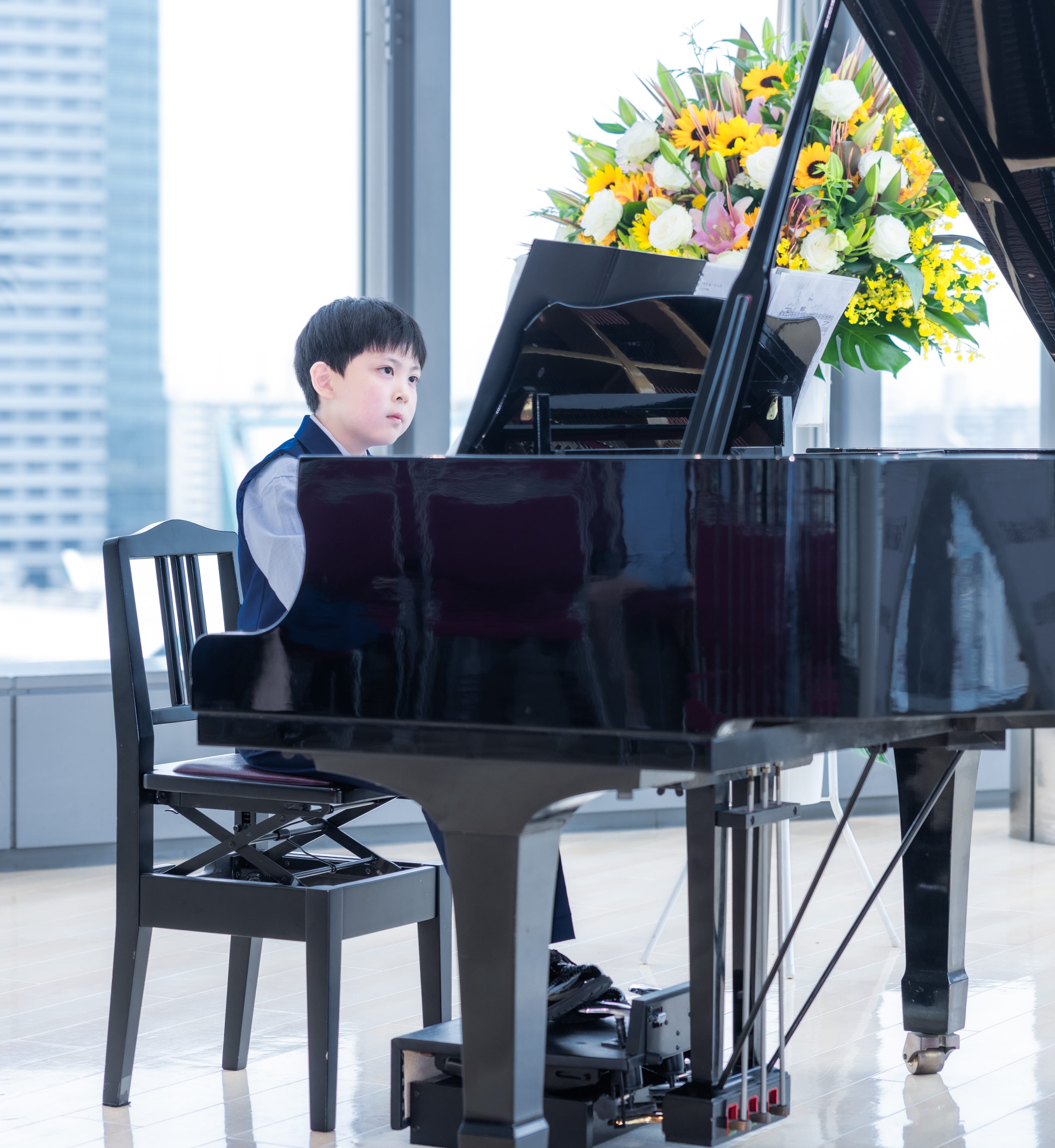 A grand piano in a beautifully lit, inspiring studio at YMI Academy.